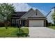 Charming brick home featuring a two-car garage, arched windows, and lush green lawn at 2163 Berryhill Se Cir, Smyrna, GA 30082