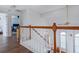 Bright hallway with hardwood floors, white railings, and natural light coming in from the window at 2163 Berryhill Se Cir, Smyrna, GA 30082