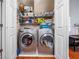 Convenient laundry area with side by side washer and dryer, and shelving for storage at 2163 Berryhill Se Cir, Smyrna, GA 30082