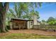 A side yard with a view of the covered back porch and lush greenery at 2201 Plantation Ln, Atlanta, GA 30341