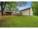 A side yard with a view of the covered back porch, a garage and lush greenery at 2201 Plantation Ln, Atlanta, GA 30341