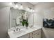 Bright bathroom featuring a double vanity with white countertops, a large mirror, and modern fixtures at 2201 Plantation Ln, Atlanta, GA 30341