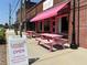 Charming bakery with a bright pink awning and outdoor seating, perfect for enjoying a sweet treat at 2201 Plantation Ln, Atlanta, GA 30341