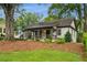 Attractive home featuring a covered front porch and a green, manicured lawn at 2201 Plantation Ln, Atlanta, GA 30341