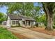 Beautiful home with a long driveway, lush trees, and mature landscaping at 2201 Plantation Ln, Atlanta, GA 30341