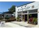 Boutique storefront with a welcoming entrance, beautiful landscaping, and an adjacent outdoor seating area at 2201 Plantation Ln, Atlanta, GA 30341