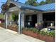 Cozy restaurant with a blue awning, exposed brick, and outdoor planters full of colorful flowers at 2201 Plantation Ln, Atlanta, GA 30341