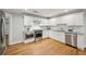 Modern kitchen with stainless steel appliances, white cabinets, and hardwood flooring at 2201 Plantation Ln, Atlanta, GA 30341