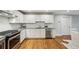 Well-lit kitchen with white cabinets, granite countertops, and stainless steel appliances at 2201 Plantation Ln, Atlanta, GA 30341