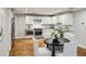 Bright eat-in kitchen features stainless steel appliances and white cabinetry at 2201 Plantation Ln, Atlanta, GA 30341