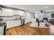 Open-concept kitchen with white cabinets, granite countertops, and stainless steel appliances at 2201 Plantation Ln, Atlanta, GA 30341