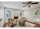 Cozy living room with fireplace, ceiling fan, and door to the outside at 2201 Plantation Ln, Atlanta, GA 30341