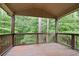 Inviting wooden back porch with scenic views of the lush greenery at 2720 Tuscany Park Dr, Lawrenceville, GA 30043
