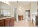 Bright bathroom with dual vanities, tiled floors, walk-in shower, soaking tub, and doorways to other rooms at 2720 Tuscany Park Dr, Lawrenceville, GA 30043