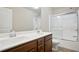 Bathroom features a double sink vanity, a shower and tub combo with glass door and modern fixtures at 2720 Tuscany Park Dr, Lawrenceville, GA 30043