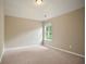 Bedroom featuring carpet, neutral walls, a window providing natural light, and a ceiling light at 2720 Tuscany Park Dr, Lawrenceville, GA 30043