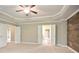 Large bedroom features a ceiling fan, carpet, neutral walls, and a decorative wood accent wall at 2720 Tuscany Park Dr, Lawrenceville, GA 30043