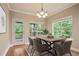Bright dining room featuring a wood table with seating for six and view to the backyard at 2720 Tuscany Park Dr, Lawrenceville, GA 30043