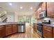 Well-equipped kitchen with stainless steel appliances, wooden cabinets, and hardwood floors at 2720 Tuscany Park Dr, Lawrenceville, GA 30043