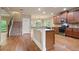 Open concept kitchen with wooden cabinets, stainless appliances, and breakfast bar at 2720 Tuscany Park Dr, Lawrenceville, GA 30043