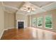 Spacious living room featuring hardwood floors, a cozy fireplace, elegant coffered ceilings, and bright windows at 2720 Tuscany Park Dr, Lawrenceville, GA 30043
