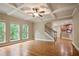 Bright and airy living room with hardwood floors, coffered ceilings, stairway, and easy access to kitchen at 2720 Tuscany Park Dr, Lawrenceville, GA 30043