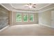 Generous main bedroom offering an accent wall, tray ceiling, three windows, and plenty of space at 2720 Tuscany Park Dr, Lawrenceville, GA 30043