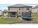 Exterior view featuring backyard, patio, trampoline, and well-maintained lawn at 3748 Spring Place Ct, Loganville, GA 30052