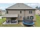 Backyard view with a covered patio and a trampoline at 3748 Spring Place Ct, Loganville, GA 30052