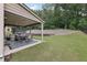 Covered patio features outdoor seating and a black and white rug, great for entertaining at 3748 Spring Place Ct, Loganville, GA 30052