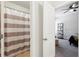 Bathroom with tub/shower combo featuring a striped curtain viewed from the bedroom at 3748 Spring Place Ct, Loganville, GA 30052