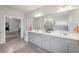This bathroom offers a double sink vanity, decorative rug, and a view into the tub and shower at 3748 Spring Place Ct, Loganville, GA 30052
