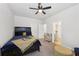Bedroom features a dark wood bed, ceiling fan and ensuite bathroom entrance at 3748 Spring Place Ct, Loganville, GA 30052