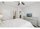 Bright bedroom with a ceiling fan, mirrored dresser, and ample natural light streaming through the window at 3748 Spring Place Ct, Loganville, GA 30052