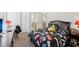 Bedroom includes game controller bedspread, dark wood bed and ensuite bathroom entrances at 3748 Spring Place Ct, Loganville, GA 30052