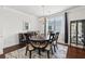 Formal dining room featuring a chandelier, hardwood floors, and ample natural light at 3748 Spring Place Ct, Loganville, GA 30052