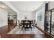 Elegant dining room with a chandelier, hardwood floors, and large windows at 3748 Spring Place Ct, Loganville, GA 30052