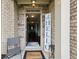 Welcoming entryway with a stone surround, 'Welcome' mat, and open view to the home interior at 3748 Spring Place Ct, Loganville, GA 30052