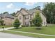Charming two-story home featuring a well-manicured lawn, lush trees, and a welcoming driveway at 3748 Spring Place Ct, Loganville, GA 30052