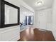 Bright foyer with hardwood floors, white wainscoting and ample lighting with a glimpse of the living area at 3748 Spring Place Ct, Loganville, GA 30052