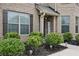 Inviting front porch with lush landscaping and a charming 'HELLO' sign at 3748 Spring Place Ct, Loganville, GA 30052