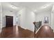 Upstairs hallway with hardwood floors, leading to various rooms and showcasing natural light and a spacious layout at 3748 Spring Place Ct, Loganville, GA 30052