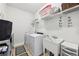 Functional laundry room with washer, dryer, sink, and wire shelving for storage solutions at 3748 Spring Place Ct, Loganville, GA 30052
