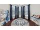 Bright living room with bay windows, hardwood floors, and stylish decor and furnishings at 3748 Spring Place Ct, Loganville, GA 30052