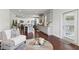 Open-concept living room and kitchen with hardwood floors and neutral decor at 3748 Spring Place Ct, Loganville, GA 30052