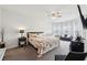 Spacious main bedroom boasts a floral patterned bedspread and a sitting area with a loveseat at 3748 Spring Place Ct, Loganville, GA 30052