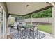 Enjoy this covered patio area featuring a full seating and dining area, perfect for entertaining at 3748 Spring Place Ct, Loganville, GA 30052