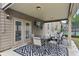 Enjoy this covered patio area featuring a full seating and dining area and views of the backyard at 3748 Spring Place Ct, Loganville, GA 30052