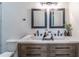 Modern bathroom features a double sink vanity with granite countertop at 20 S Eugenia Nw Pl, Atlanta, GA 30318