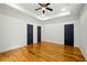Large bedroom with beautiful wood floors, ceiling fan, and multiple closets at 20 S Eugenia Nw Pl, Atlanta, GA 30318